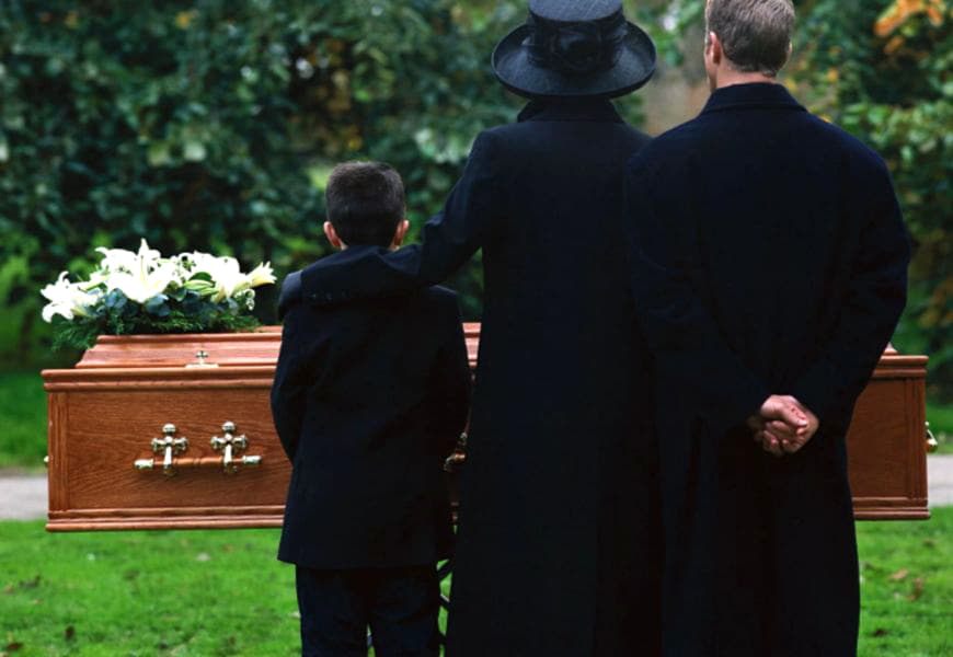 Семья в траурной одежде на похоронах 